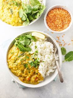 two bowls filled with different types of food next to some rice and spinach leaves