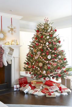 a decorated christmas tree with presents under it