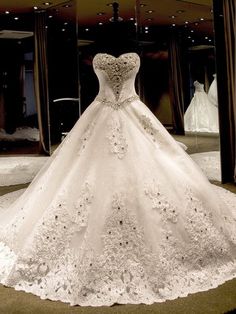 a white wedding dress on display in a store