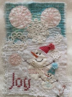 a close up of a snowman on a doily