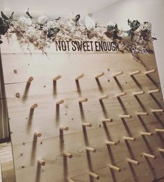 a wooden wall with birds on it and the words not sweet enough