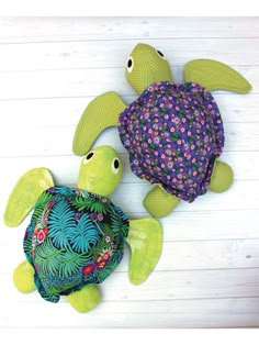 two stuffed animals made to look like turtles