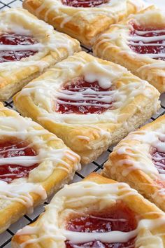 strawberry shortbreads with icing on a cooling rack ready to be baked in the oven