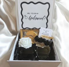 an open box containing sunglasses and a card that says will you be my girlfriend?