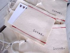 several pieces of paper with words on them and string attached to the back of each piece