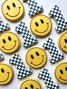 decorated cookies with smiley face and checkerboard designs on them are arranged in the shape of squares