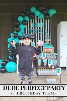 a young boy standing in front of a birthday party