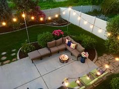 an aerial view of a backyard with patio furniture and string lights