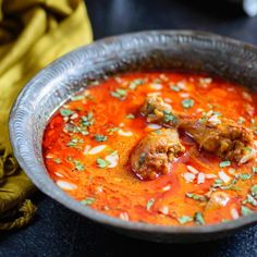 a metal bowl filled with meatballs and tomato sauce