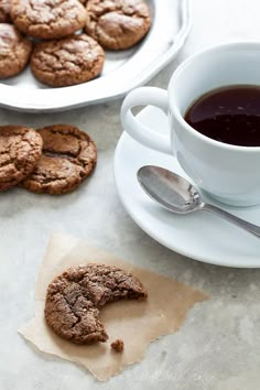 a cup of coffee and some cookies on a table