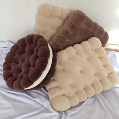 three pillows sitting on top of a bed next to each other