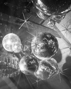 disco balls hanging from the ceiling in black and white