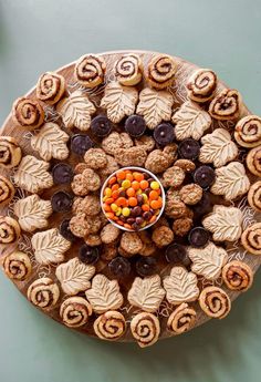 a wooden platter filled with cookies and candies