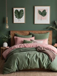 a bed with green and pink comforters in a bedroom next to two pictures on the wall