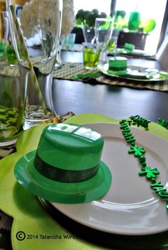 a st patrick's day table setting with green and white plates