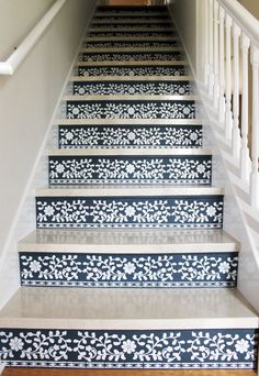 the stairs are painted with blue and white flowers