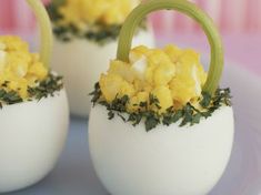 three white eggs with yellow flowers in them