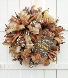 an autumn wreath is hanging on the side of a white door that reads, i have been waiting for autumn is coming