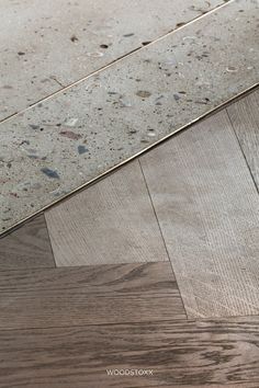 a close up of a wooden floor with white and brown wood grains on it