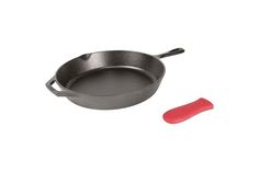 an empty frying pan with a red spatula next to it on a white background