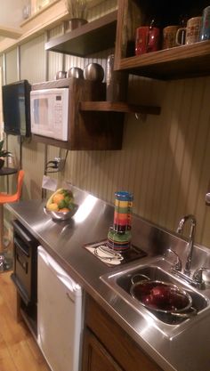 a kitchen with stainless steel sink and dishwasher