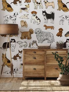 a wall with dogs painted on it and a lamp next to the dresser in front