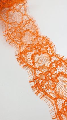 an orange lace on a white surface