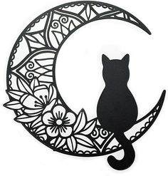 a black cat sitting on top of a crescent with flowers in the moon cutout