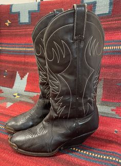 "From Blackbird Vintage of Sedona, Arizona  This is a great pair of authentic Vintage Men's Black Cowboy boots, size 8 D. (Most likely would also fit a ladies 9.5) 12\" tall.  They feature silver metal tips, a very unique heel and are made in Mexico, circa 1950s. measurements: Height: 14 inches, inclusive of 2 3/8 inch heel Heel to toe: 10.5 inches width, widest part of sole: 3 7/8 inches circumference around top of calf: 15\" They are quite distressed and very worn in, with many scuffs and nick Vintage Brown Boots For Western-themed Events, Fitted Vintage Black Boots, Vintage Black Winter Boots, Vintage Fitted Boots With Leather Sole, Vintage Snip Toe Boots For Formal Occasions, Vintage Formal Boots For Winter, Vintage Western Boots With Pointed Toe, Vintage Black Boots For Rodeo, Vintage Goodyear Welted Boots For Fall