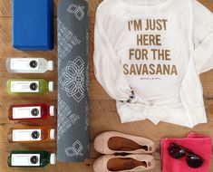 the contents of a woman's personal care kit laid out on a wooden surface