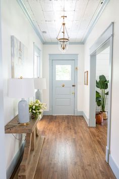 Historic Home Renovation - Home Tour - Farmhouse Living - Gold Pendant Light - Shiplap Ceiling - Sleepy Blue Trim - Blue Painted Front Door - Entry Way Inspiration - Hardwood Floors White Blue Wall Paint, Blue Ceiling Entryway, Blue Interior Trim And Doors, Blue Trim Living Room, White Walls Blue Trim Bathroom, Blue Contrast Trim Interior, Light Blue Foyer, White Walls Blue Trim Bedroom, White Walls Blue Accent Wall