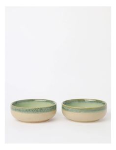 two green and white bowls sitting next to each other