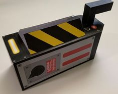 an electronic device with a yellow and black hazard stripe on it's back side