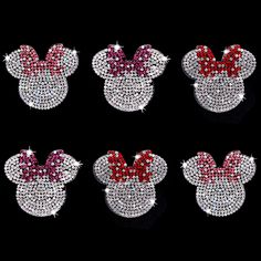 four minnie mouse head brooches with red and white bows on them, all made out of swarong crystals