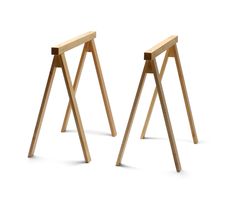 two wooden stools sitting next to each other on a white surface with one standing up