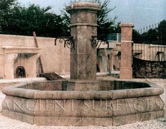 an old fountain in front of a building