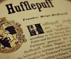 a close up of a newspaper with an image of a hogwarts crest on it