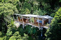 an aerial view of a house in the middle of some trees and greenery,