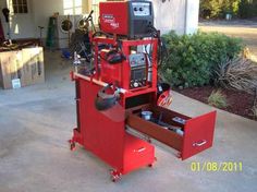 a red tool box sitting on top of a garage floor