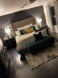 a bedroom with a large bed and two lamps on either side of the headboard