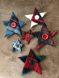 five plaid fabric stars with buttons on them sitting on the floor next to each other