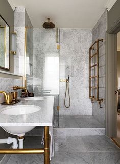 a bathroom with marble and gold fixtures