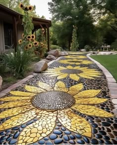 a garden path with sunflowers painted on it