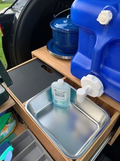 the inside of a van with blue containers and trays