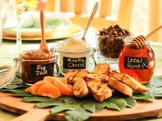 there are many different types of food on the table together, including honey and orange slices