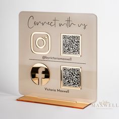 a white and gold plaque with qr - code on it that says connect with us