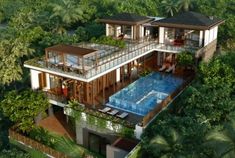 an aerial view of a two story house with a swimming pool in the foreground