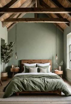 a bedroom with green walls and wooden beams