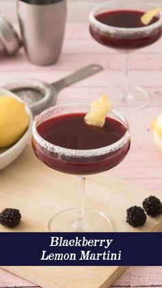 two glasses of blackberry lemon martini on a cutting board