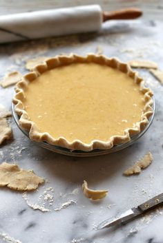 an uncooked pie crust sitting on top of a table